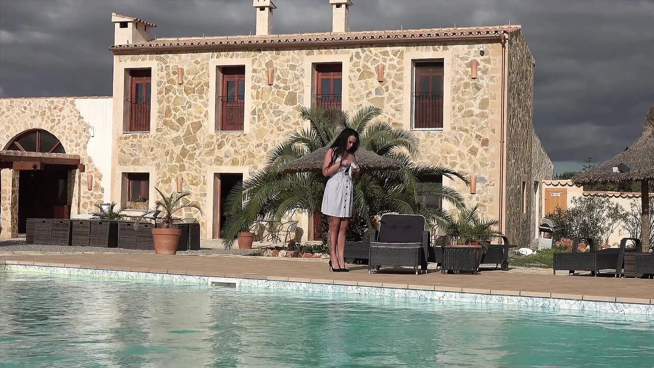 Hot Ilona Lies by the Pool and Rubs Her Pussy and Dildo with Oil
