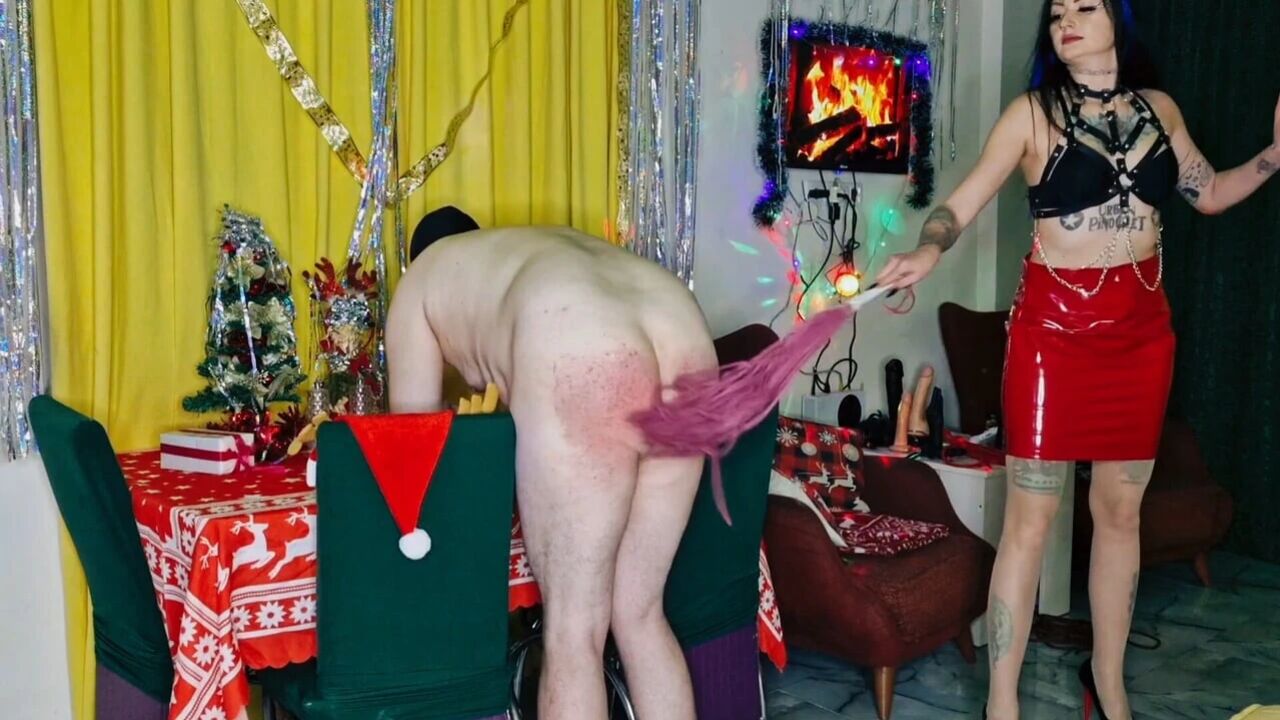 Christmas Punishment. Dominatrix Nika spanked a slave's ass. Pain and red buttocks.