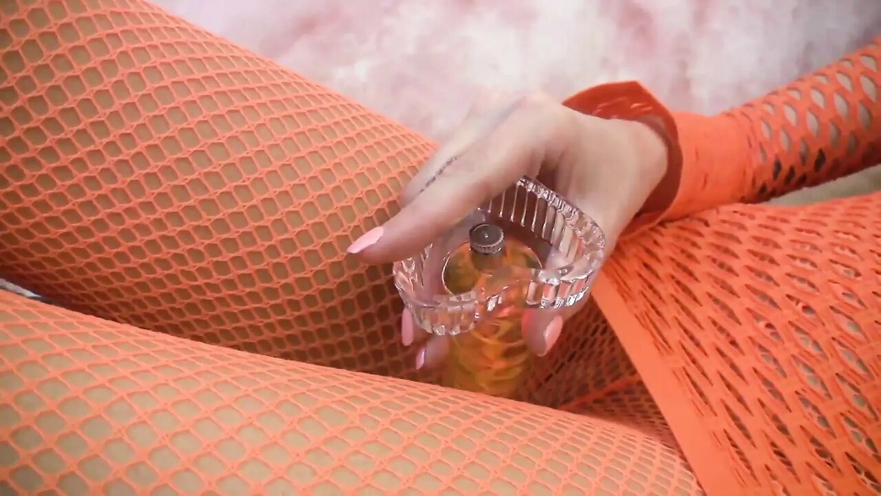 Babe in fishnet outfit rips pantyhose and puts a dildo in her shaved cunt