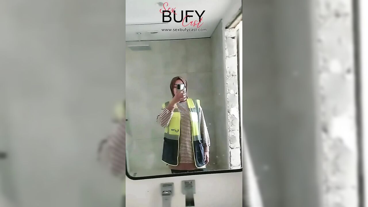 Turkish girl with headscarf who turns on the camera and puts on a show at the construction site