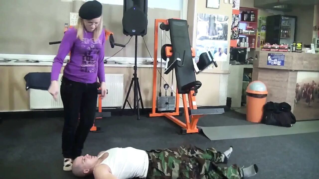 Blonde slut with glasses and her slave in gym