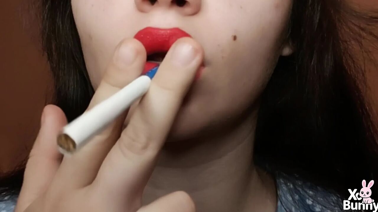 Big red lips smoking close up