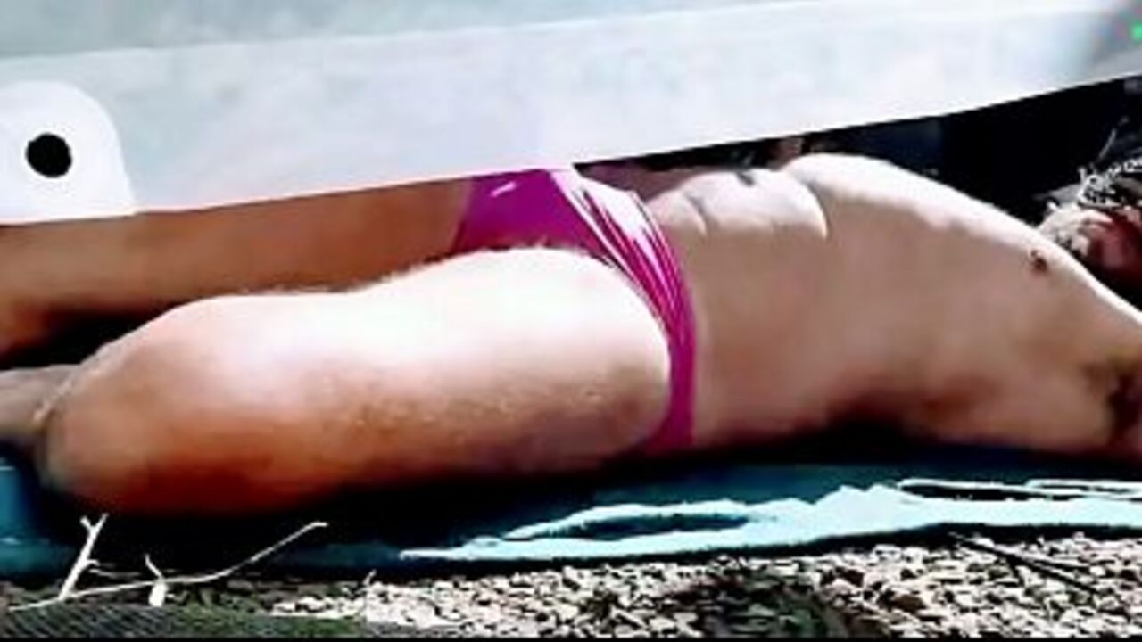 Caressing his penis through his pink underwear