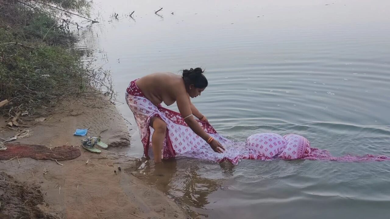 Indian village wife bathing in the river in outdoor area