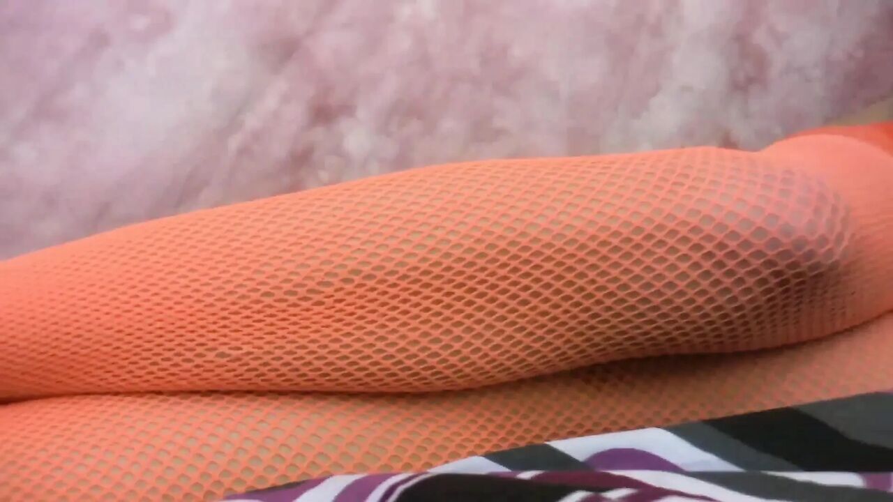 Babe in fishnet outfit rips pantyhose and puts a dildo in her shaved cunt