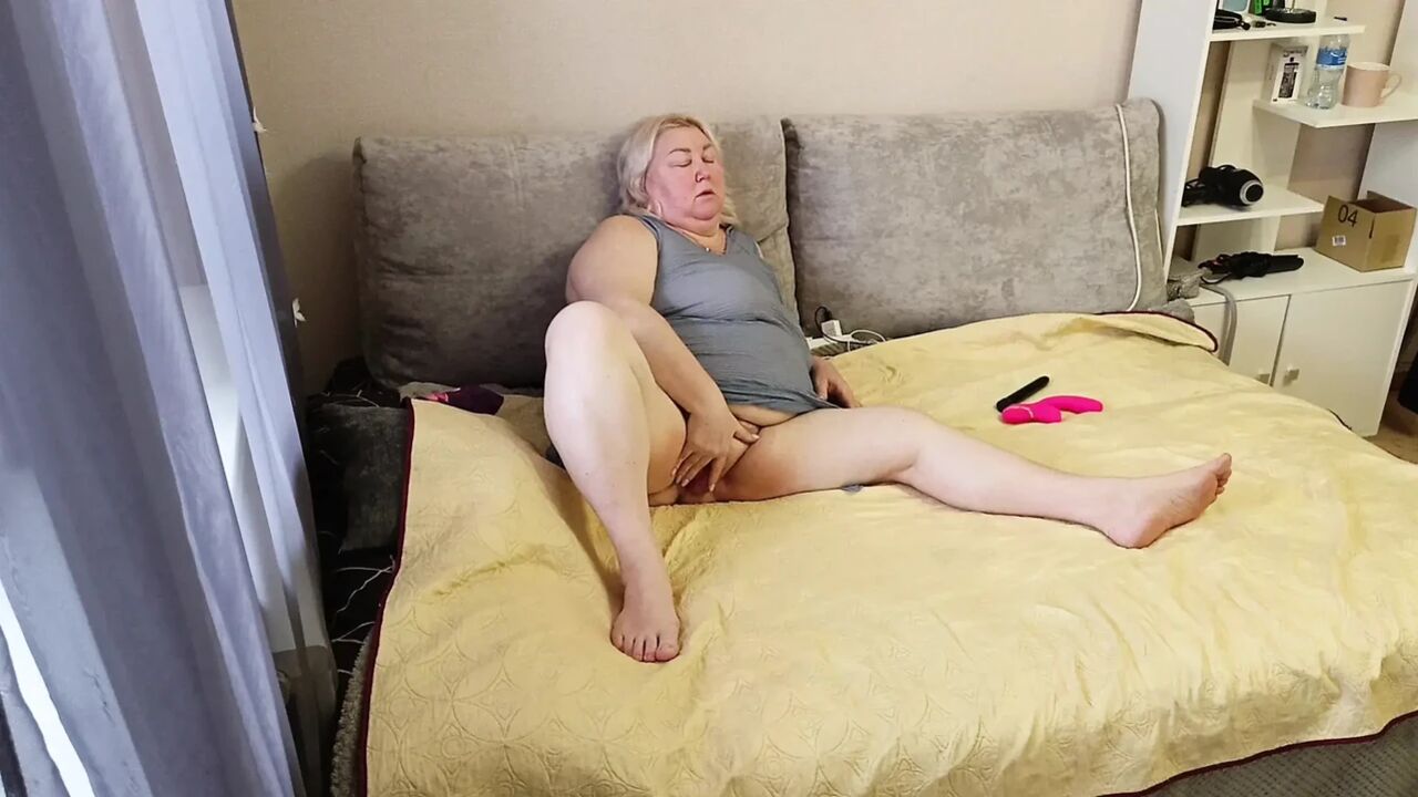 a neighbor plays with a toy with a big pussy and rubs her tits