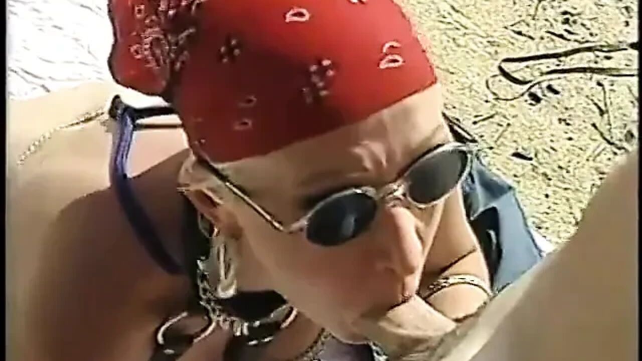 Lusty slut in leather gear rides a young stud dick in desert