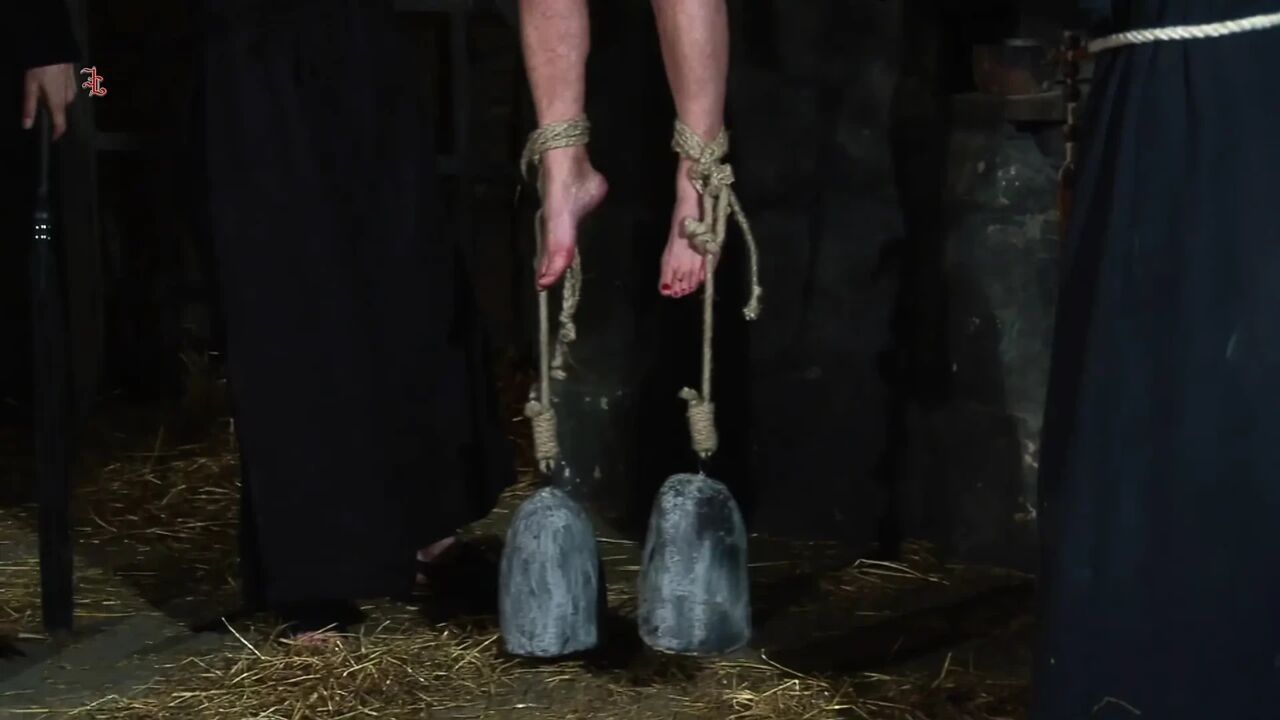 Blonde Girl Has Weights Attached to Her Feet and Is Hoisted up for Whipping