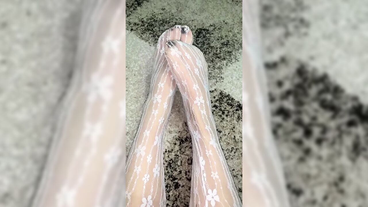 Massaging feet in sexy socks with hands in gloves