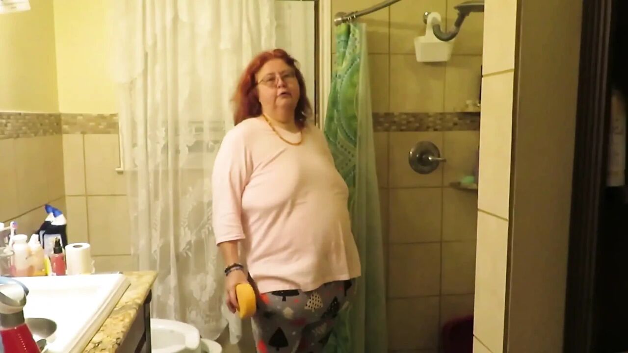 Step mom cleaning bathroom thinks of her step son watching