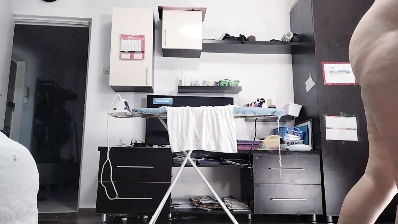 Sexy brunette doing naked chores around the house.
