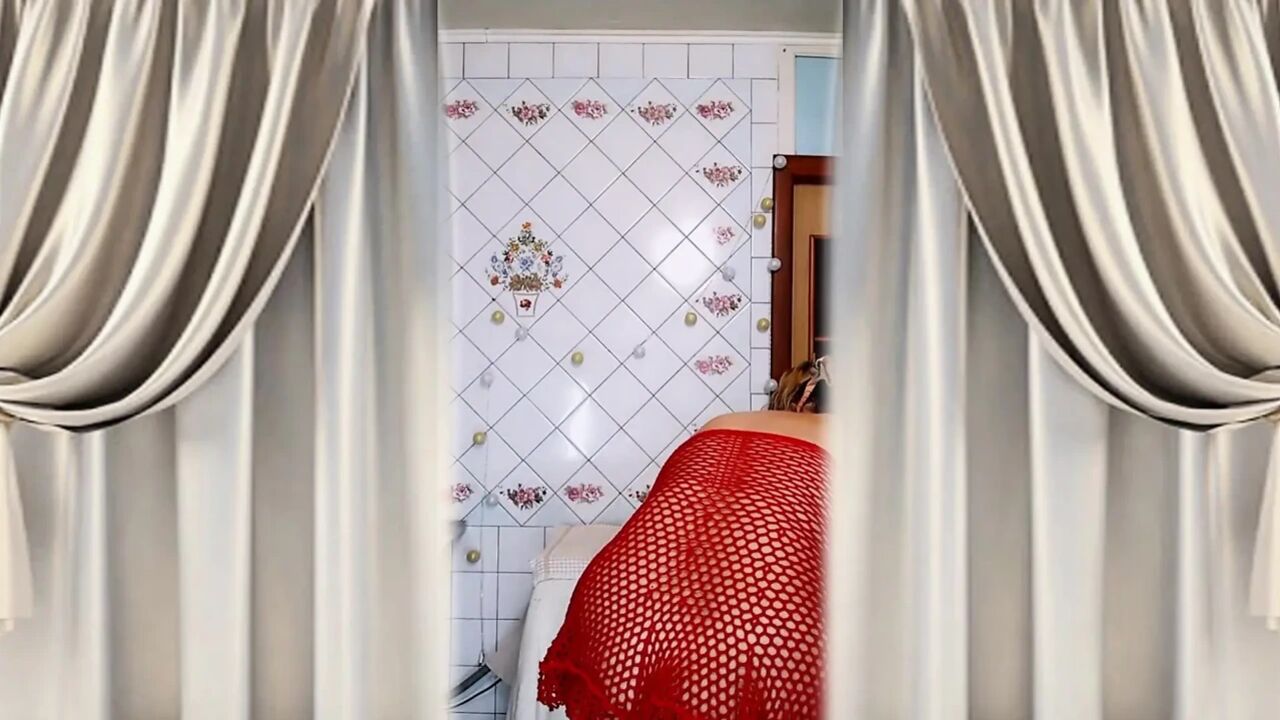 Hot housewife Lukerya changes into a red bodysuit and flirts in the kitchen.