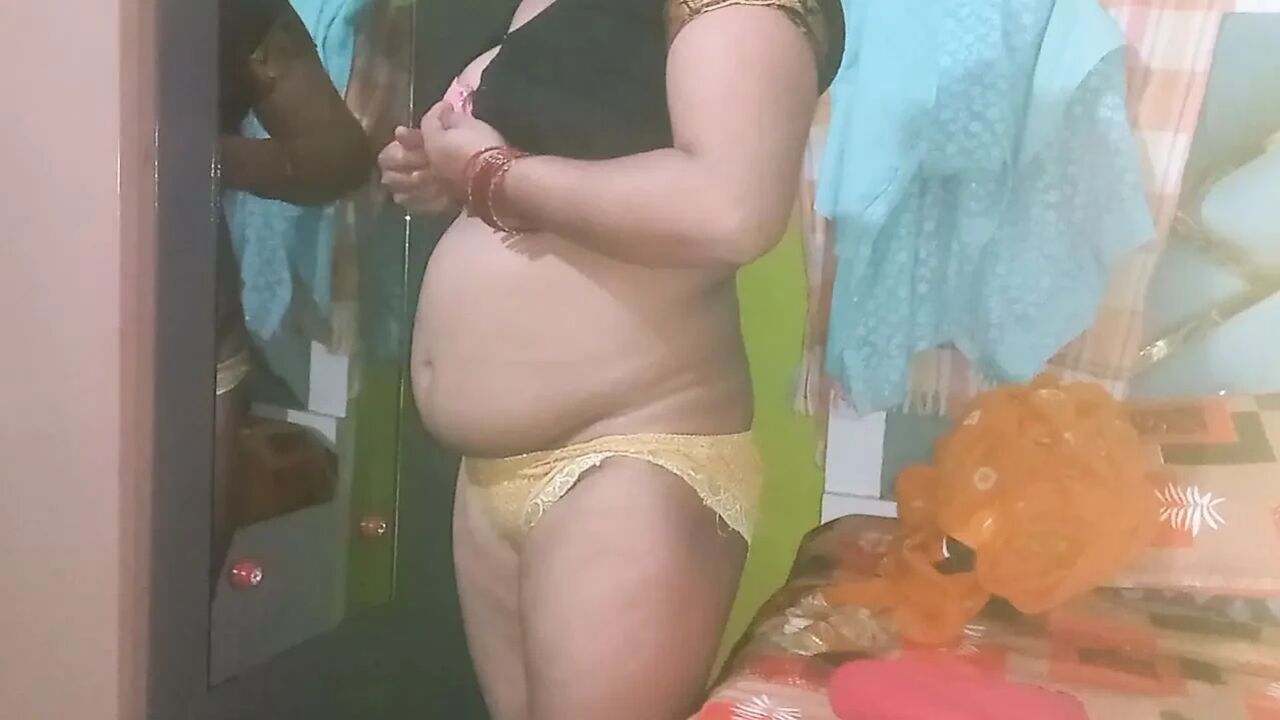 Indian housewife is wearing a yellow saree.