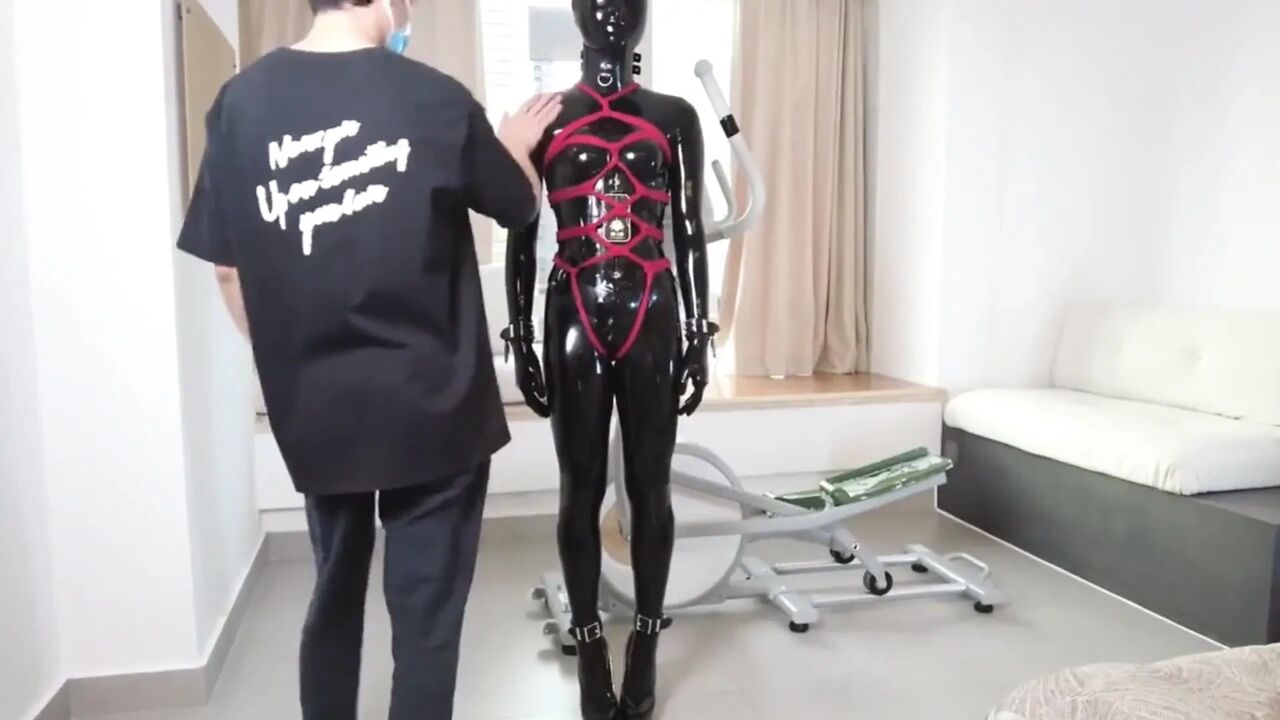 Mz27 - a Girl Bound in Latex Walks on a Treadmill