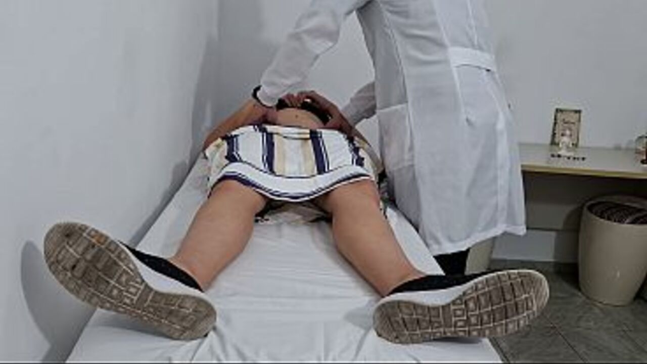 Medical examination of the patient's abdomen in the doctor's office.